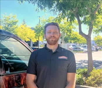 man smiling next to truck