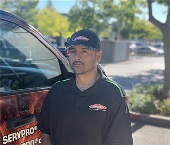 man smiling next to truck